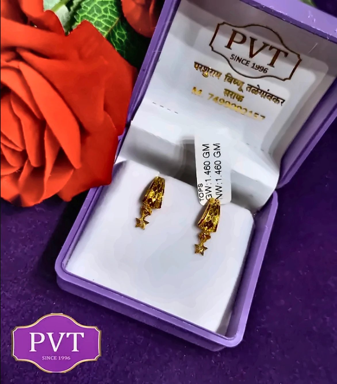 Pair of gold earrings with star drops in a purple PVT gift box